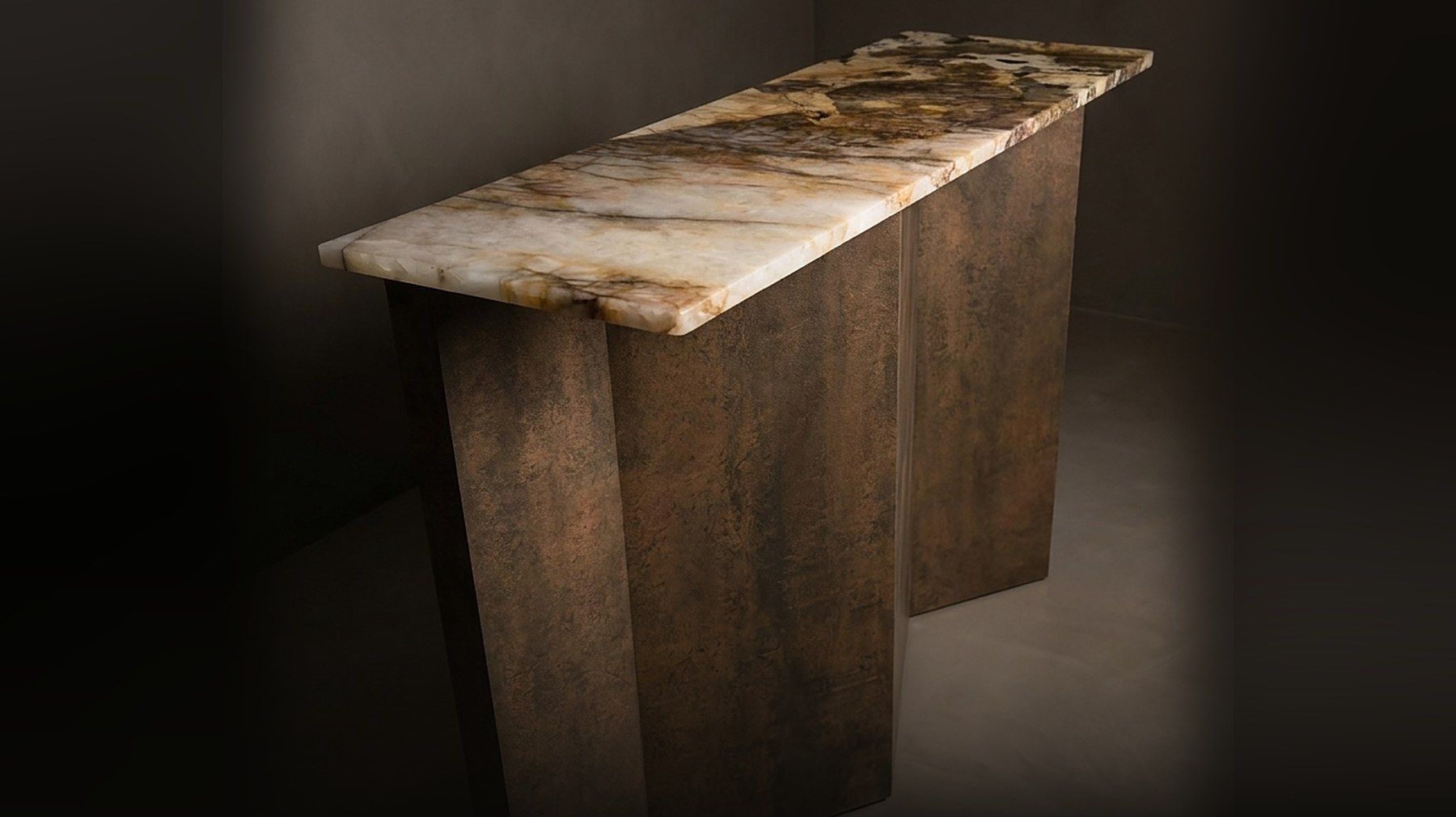 The Folded Console — a one-of-one Corten Iron Neolith console with a Patagonia quartzite top, in a dark gallery