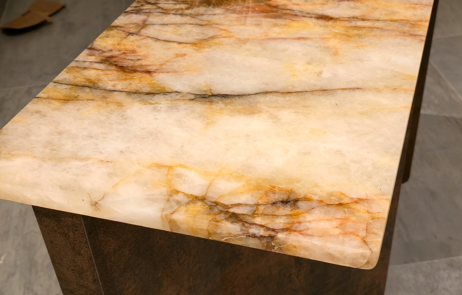 Patagonia quartzite at close range — amber, oxblood and black veining running through translucent white crystal