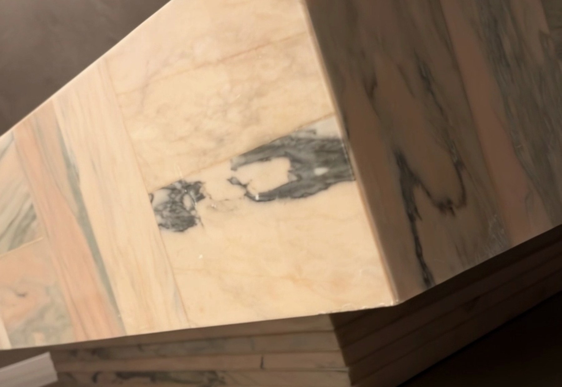La Rosa from floor level — the stepped stone plinth beneath the woven slab